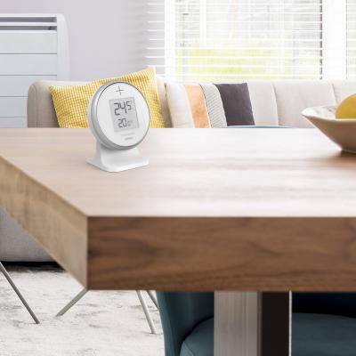 le Thermostat thomson at home posé sur une table en bois